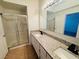 Modern bathroom with double vanity, granite countertop, and walk-in shower at 3205 Mystic Ridge Ct, Las Vegas, NV 89129