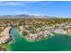 Beautiful lakefront neighborhood featuring custom homes with private docks and lush landscaping against a mountain backdrop at 3305 Cutty Sark St, Las Vegas, NV 89117