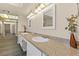 Double vanity bathroom with granite countertops and large mirrors at 3305 Cutty Sark St, Las Vegas, NV 89117