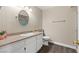 Clean bathroom with granite vanity and oval mirror at 3305 Cutty Sark St, Las Vegas, NV 89117