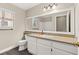 Bright bathroom featuring a large vanity mirror, white cabinets, and a shower-tub combination at 3305 Cutty Sark St, Las Vegas, NV 89117