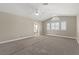 Large, carpeted bedroom with vaulted ceiling, and a peek into the bathroom and vanity area at 3305 Cutty Sark St, Las Vegas, NV 89117