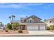 Two-story home with three-car garage and desert landscaping at 3305 Cutty Sark St, Las Vegas, NV 89117