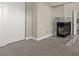 Cozy fireplace in a neutral-toned carpeted room, accented by a tiled hearth and a nearby closet at 3305 Cutty Sark St, Las Vegas, NV 89117