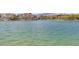 Scenic lake view featuring waterfront homes and mountain views in the distance at 3305 Cutty Sark St, Las Vegas, NV 89117