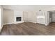 Spacious living room featuring wood floors, white brick fireplace and a built-in wet bar at 3305 Cutty Sark St, Las Vegas, NV 89117