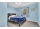 Bedroom with full bed and light blue walls at 3398 El Camino Real, Las Vegas, NV 89121