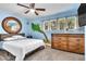 Bright bedroom with beach mural, dresser, and ceiling fan at 3398 El Camino Real, Las Vegas, NV 89121