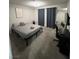 Cozy bedroom features a simple bed frame, grey carpet, and an adjacent desk area at 3625 Winner Dr, Las Vegas, NV 89120