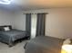 Comfortable bedroom featuring two beds with plush gray bedding and soft lighting at 3625 Winner Dr, Las Vegas, NV 89120