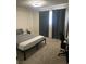 Bright bedroom offering a comfortable bed, dark curtains, and convenient desk space at 3625 Winner Dr, Las Vegas, NV 89120