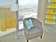 Comfortable chair by a large window with city views, complemented by a stylish floor lamp at 3722 Las Vegas Blvd # 3209, Las Vegas, NV 89158