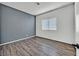 Bright bedroom with gray accent wall and wood-look flooring at 3757 Grand Viewpoint Ct, Las Vegas, NV 89147