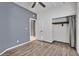 Bedroom with gray accent wall, ceiling fan, and wood-look flooring at 3757 Grand Viewpoint Ct, Las Vegas, NV 89147