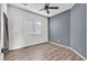 Bedroom with gray accent wall, ceiling fan, and wood-look flooring at 3757 Grand Viewpoint Ct, Las Vegas, NV 89147