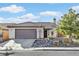 Single-story home with a brown garage door and landscaped front yard at 3757 Grand Viewpoint Ct, Las Vegas, NV 89147