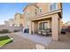 Exterior of home showcasing covered patio with table set and a well-maintained yard at 3770 S Rosy Carina Pl, Henderson, NV 89052