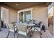 Charming covered patio with outdoor seating, potted plants, and workout equipment at 3770 S Rosy Carina Pl, Henderson, NV 89052