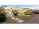 Landscaped backyard featuring gravel, artificial turf, and cozy outdoor lounge area at 3770 S Rosy Carina Pl, Henderson, NV 89052