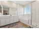 Bathroom featuring a large tub, glass shower, double vanity, and wood-look tile flooring at 3770 S Rosy Carina Pl, Henderson, NV 89052