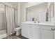 Bathroom featuring white cabinetry, a large mirror, and a shower with white subway tiles at 3770 S Rosy Carina Pl, Henderson, NV 89052