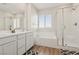 Bright bathroom featuring double vanity, separate tub and shower, and modern fixtures at 3770 S Rosy Carina Pl, Henderson, NV 89052