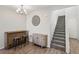 Light and airy foyer with stairs, tiled floors, modern light fixture and bar at 3770 S Rosy Carina Pl, Henderson, NV 89052