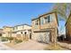 Two-story home featuring stone accents, neutral paint, blue shutters and manicured landscaping at 3770 S Rosy Carina Pl, Henderson, NV 89052