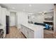 Kitchen with stainless steel appliances, white cabinets, an island, and an open view to the living area at 3770 S Rosy Carina Pl, Henderson, NV 89052