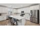 Bright kitchen with stainless steel appliances, white cabinetry, an island and stylish countertops at 3770 S Rosy Carina Pl, Henderson, NV 89052