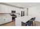 Modern kitchen featuring white cabinets, stainless steel appliances, and a large center island at 3770 S Rosy Carina Pl, Henderson, NV 89052