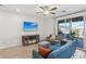 Bright living room featuring a sliding glass door, stylish furnishings and tile floors at 3770 S Rosy Carina Pl, Henderson, NV 89052