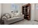 Cozy living room featuring a couch, bookshelf and a window at 3770 S Rosy Carina Pl, Henderson, NV 89052