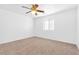 Simple bedroom with ceiling fan and window at 4050 Sparrow Rock St, Las Vegas, NV 89129