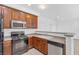 Modern kitchen with dark wood cabinets and stainless steel appliances at 4050 Sparrow Rock St, Las Vegas, NV 89129