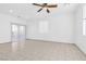 Bright and airy living room with tile floors and a sliding door to the patio at 4050 Sparrow Rock St, Las Vegas, NV 89129