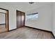 Bedroom with wood-look floors, large window, and roomy closet at 4151 Calimesa St, Las Vegas, NV 89115