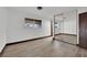 Cozy bedroom featuring wood-look floors, neutral paint, and natural light at 4151 Calimesa St, Las Vegas, NV 89115