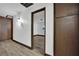 Hallway featuring wood-look floors, storage cabinets, and neutral walls at 4151 Calimesa St, Las Vegas, NV 89115