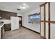 Kitchen featuring modern appliances, dark cabinets, and wood-look floors at 4151 Calimesa St, Las Vegas, NV 89115