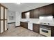 Kitchen with wood cabinets, white appliances, and white countertops at 4151 Calimesa St, Las Vegas, NV 89115