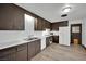 Kitchen featuring wood cabinets, white appliances, and wood-look floors at 4151 Calimesa St, Las Vegas, NV 89115