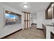 Bright kitchen featuring wood-style flooring, modern cabinets, and a sunlit window with neighborhood views at 4151 Calimesa St, Las Vegas, NV 89115