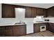 Kitchen with white counters, dark wood cabinets, and a stainless sink at 4151 Calimesa St, Las Vegas, NV 89115