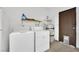 Functional laundry area with washer, dryer, utility sink, and storage shelves for convenience and organization at 4151 Calimesa St, Las Vegas, NV 89115