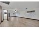 Bright living room featuring wood-look floors, a ceiling fan, and seamlessly flowing to other rooms at 4151 Calimesa St, Las Vegas, NV 89115