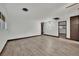 Inviting living room featuring wood-look floors, neutral paint, and easy access to other rooms at 4151 Calimesa St, Las Vegas, NV 89115