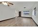 Bright living room featuring wood-look floors, a ceiling fan, and a large window at 4151 Calimesa St, Las Vegas, NV 89115