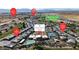 Community aerial view displaying amenities like the clubhouse, pool, tennis courts, and surrounding residential areas at 4267 E Highvale Ct, Pahrump, NV 89061