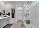 Modern bathroom featuring double sinks, white cabinets and a large glass shower at 4267 E Highvale Ct, Pahrump, NV 89061